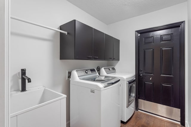 9544 Mockingbird Trl, Jupiter, FL 33478 - clothes washing area featuring washer and dryer, cabinet space, dark wood-style floors, and a textured ceiling