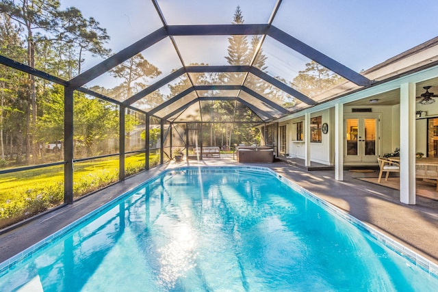 9544 Mockingbird Trl, Jupiter, FL 33478 - swimming pool featuring a hot tub, french doors, a patio, and a lanai