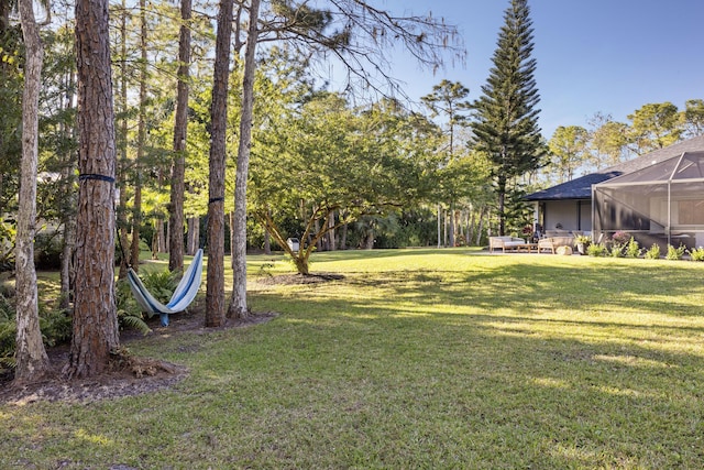 9544 Mockingbird Trl, Jupiter, FL 33478 - view of grassy yard featuring a lanai