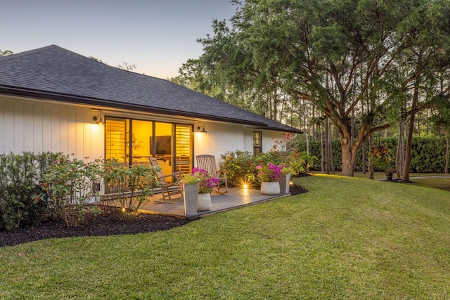 9544 Mockingbird Trl, Jupiter, FL 33478 - yard at dusk featuring a lawn and a deck