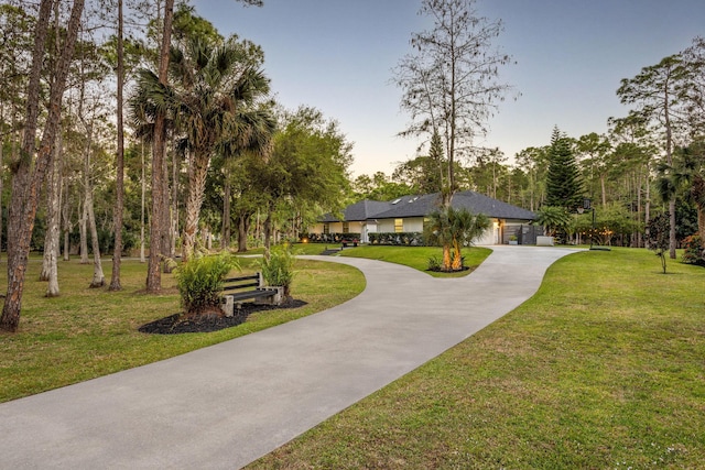 9544 Mockingbird Trl, Jupiter, FL 33478 - surrounding community with driveway, a yard, and a garage