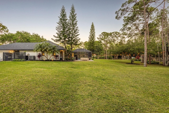 9544 Mockingbird Trl, Jupiter, FL 33478 - view of green lawn with central air condition unit and glass enclosure
