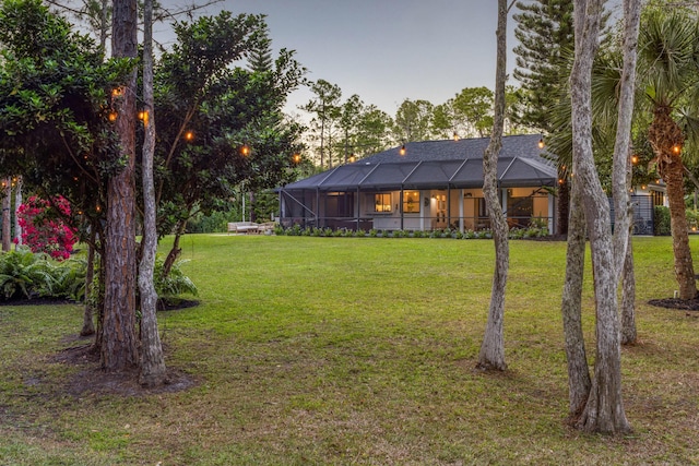 9544 Mockingbird Trl, Jupiter, FL 33478 - view of grassy yard with glass enclosure