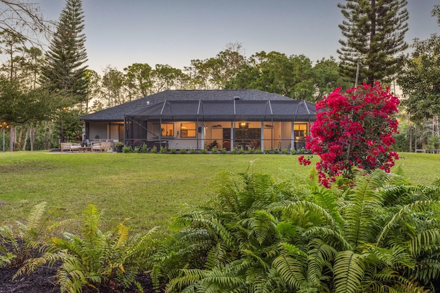 9544 Mockingbird Trl, Jupiter, FL 33478 - back of house featuring a lawn and a lanai