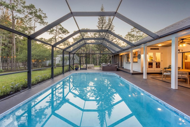 9544 Mockingbird Trl, Jupiter, FL 33478 - swimming pool with a hot tub, french doors, a patio, a lanai, and a lawn