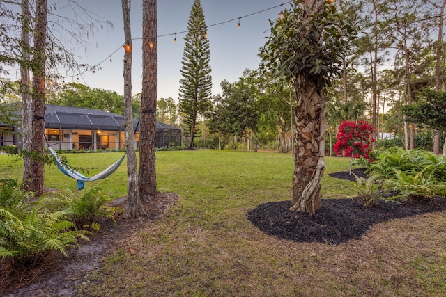 9544 Mockingbird Trl, Jupiter, FL 33478 - view of grassy yard with a lanai