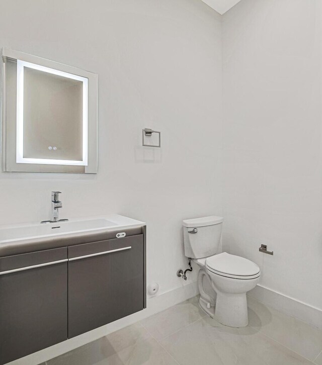 2929 Lorene Dr, Palm Springs, FL 33461 - half bath with baseboards, toilet, vanity, and tile patterned floors