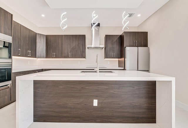 2929 Lorene Dr, Palm Springs, FL 33461 - kitchen featuring appliances with stainless steel finishes, wall chimney range hood, modern cabinets, dark brown cabinetry, and recessed lighting