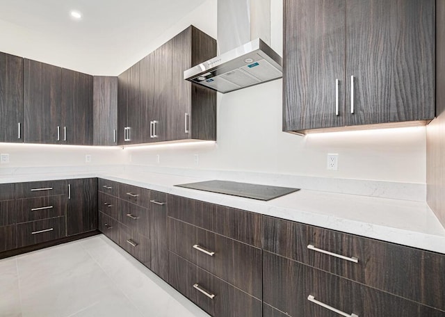 2929 Lorene Dr, Palm Springs, FL 33461 - kitchen with wall chimney range hood, black electric cooktop, dark brown cabinets, and light countertops