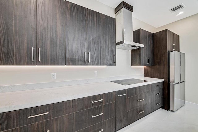 2929 Lorene Dr, Palm Springs, FL 33461 - kitchen with black electric cooktop, freestanding refrigerator, wall chimney range hood, dark brown cabinetry, and modern cabinets