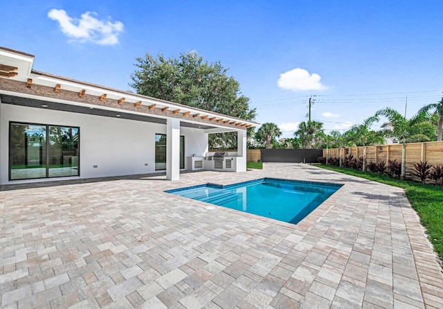 2929 Lorene Dr, Palm Springs, FL 33461 - view of pool featuring exterior kitchen, fence, and a patio