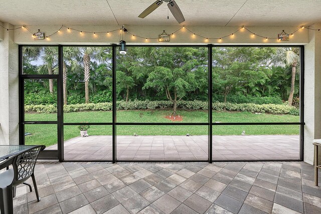 9319 Silver Shores Ln, Boynton Beach, FL 33473 - unfurnished sunroom featuring a ceiling fan