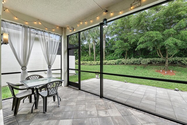 9319 Silver Shores Ln, Boynton Beach, FL 33473 - sunroom / solarium with view of scattered trees