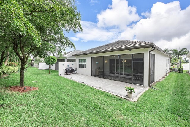 9319 Silver Shores Ln, Boynton Beach, FL 33473 - back of house featuring a patio, a tiled roof, a yard, and a sunroom