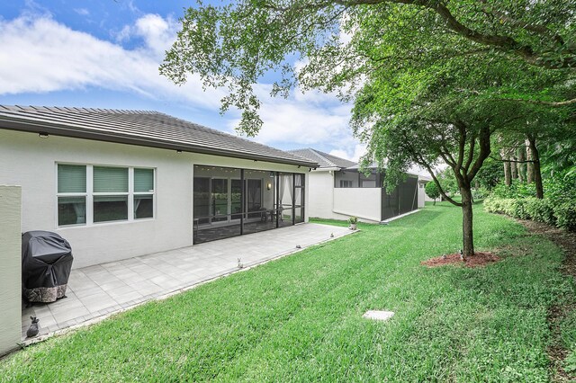 9319 Silver Shores Ln, Boynton Beach, FL 33473 - view of green lawn with a sunroom and a patio area