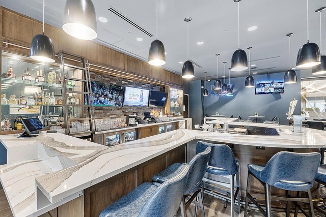 9319 Silver Shores Ln, Boynton Beach, FL 33473 - indoor wet bar featuring decorative light fixtures