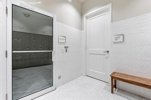 9319 Silver Shores Ln, Boynton Beach, FL 33473 - bathroom featuring tile walls and tile patterned floors