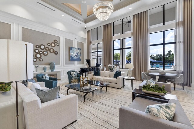9319 Silver Shores Ln, Boynton Beach, FL 33473 - living area with a towering ceiling, a decorative wall, a chandelier, ornamental molding, and recessed lighting