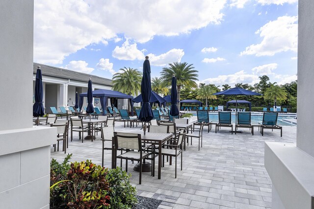 9319 Silver Shores Ln, Boynton Beach, FL 33473 - view of patio / terrace featuring a community pool