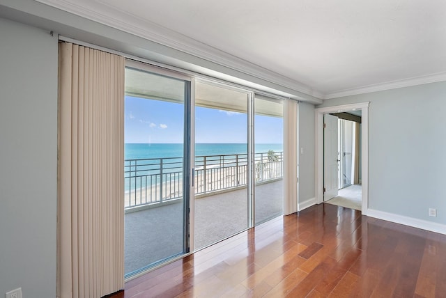 350 Beach Rd Unit 503, Tequesta, FL 33469 - spare room featuring a water view, crown molding, wood finished floors, and baseboards