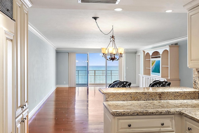 350 Beach Rd Unit 503, Tequesta, FL 33469 - kitchen with ornamental molding, a water view, wood finished floors, a chandelier, and hanging light fixtures