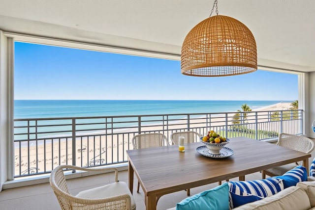 350 Beach Rd Unit 503, Tequesta, FL 33469 - balcony with view of water and beach, outdoor dining space, and an outdoor hangout area