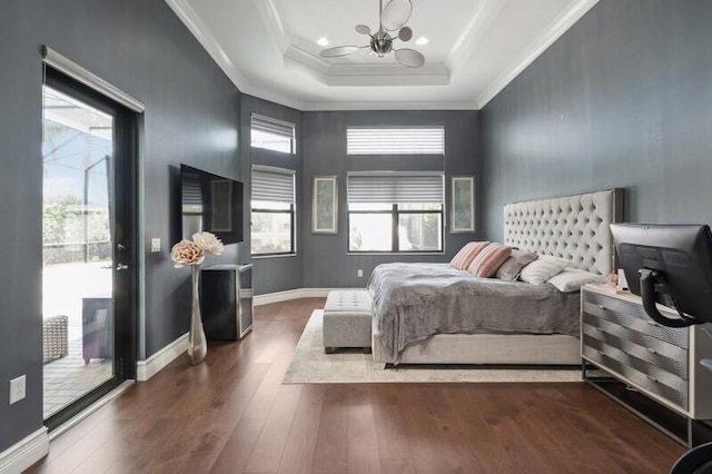 bedroom with access to outside, a chandelier, wood finished floors, a tray ceiling, and crown molding
