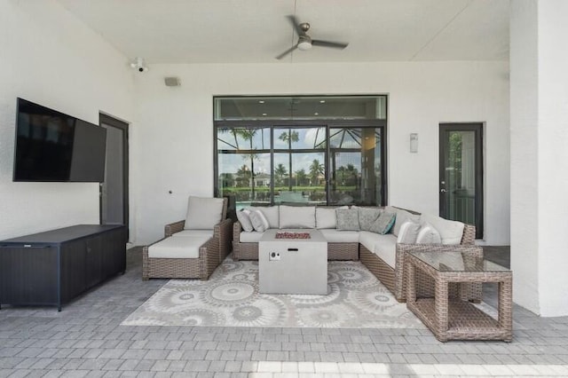 view of patio featuring an outdoor living space with a fire pit and a ceiling fan