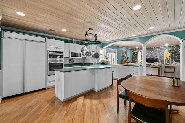 11151 88th Rd N, Palm Beach Gardens, FL 33412 - kitchen featuring ornate columns, stainless steel double oven, wooden ceiling, white dishwasher, and white cabinetry