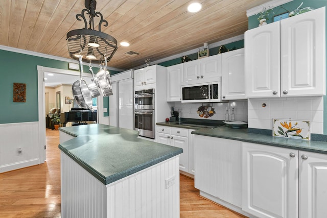 11151 88th Rd N, Palm Beach Gardens, FL 33412 - kitchen with double oven, dark countertops, wooden ceiling, ornamental molding, and white cabinets