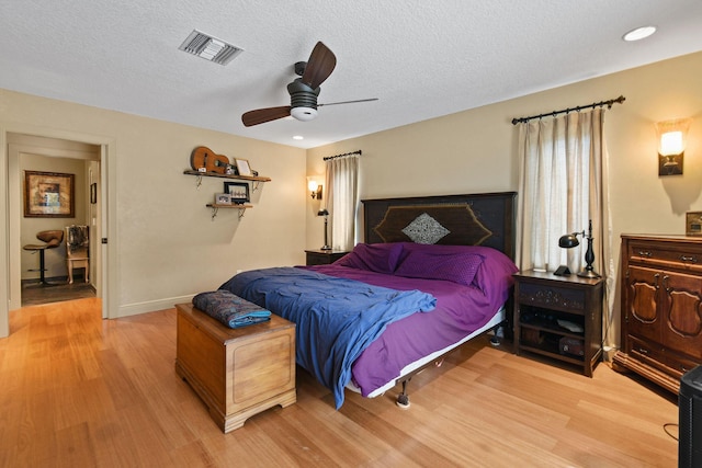 11151 88th Rd N, Palm Beach Gardens, FL 33412 - bedroom featuring light wood finished floors, a ceiling fan, a textured ceiling, and baseboards