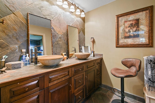 11151 88th Rd N, Palm Beach Gardens, FL 33412 - bathroom featuring double vanity, a textured ceiling, and baseboards