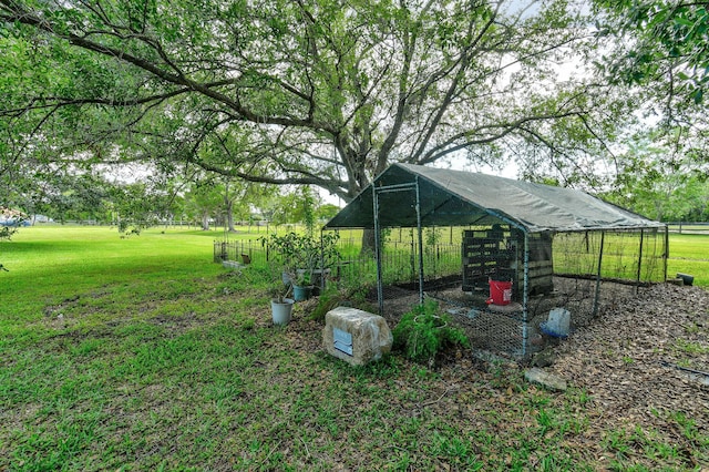 11151 88th Rd N, Palm Beach Gardens, FL 33412 - view of grassy yard with exterior structure and an outdoor structure