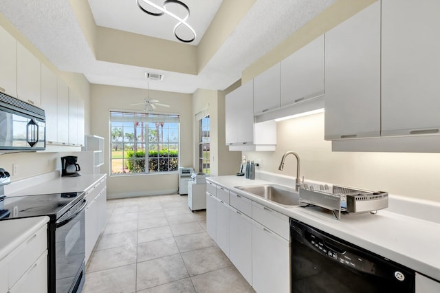 kitchen featuring black appliances, a sink, a ceiling fan, light countertops, and light tile patterned floors
