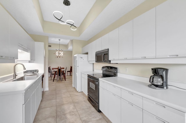 kitchen with black appliances, a sink, a chandelier, and light countertops