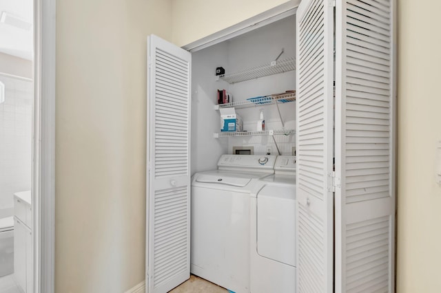 washroom with washing machine and clothes dryer