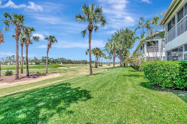 view of green lawn with golf course view