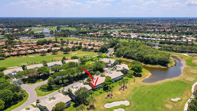aerial view of property's location featuring a nearby body of water, a golf course, and nearby suburban area