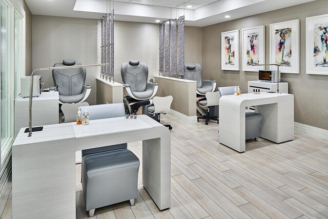 home office featuring a raised ceiling, wood finished floors, baseboards, and recessed lighting