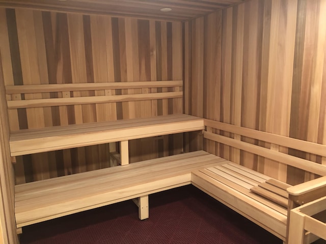 relaxing sauna / steam room featuring wallpapered walls