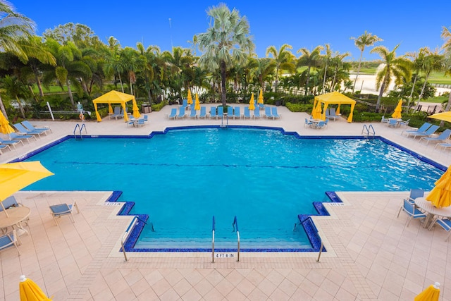 community pool with a patio and a gazebo