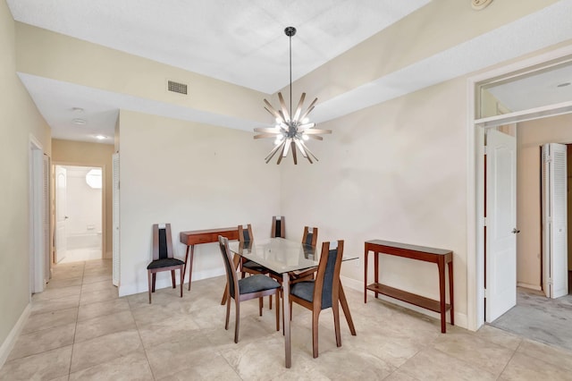 dining room featuring a chandelier, baseboards, and light tile patterned floors