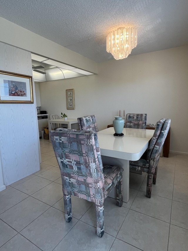4047 Ainslie C, Boca Raton, FL 33434 - dining room featuring light tile patterned floors, a textured ceiling, and a chandelier
