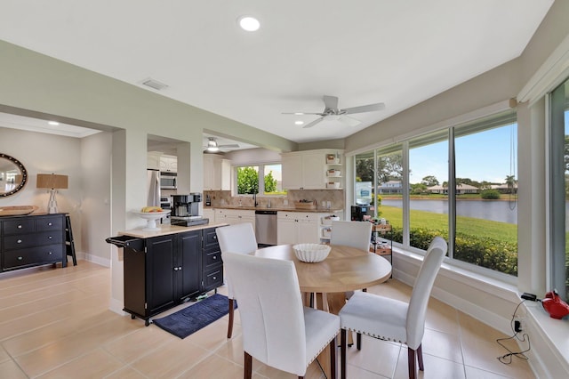 5 Slash Pine Dr, Boynton Beach, FL 33436 - dining space featuring a water view, a ceiling fan, baseboards, light tile patterned floors, and recessed lighting