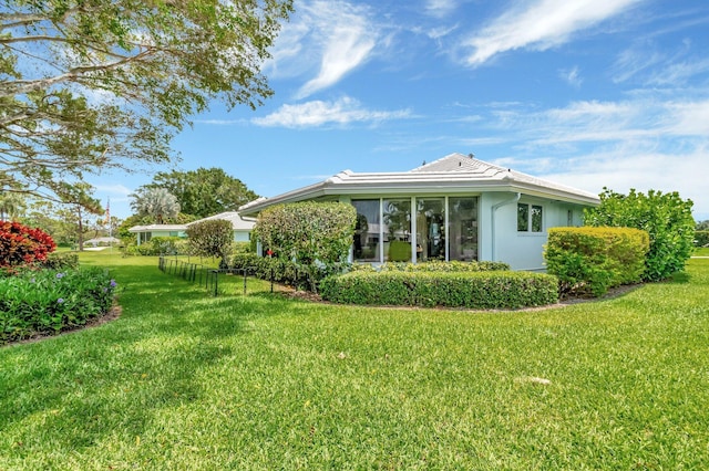 5 Slash Pine Dr, Boynton Beach, FL 33436 - view of property exterior featuring a lawn and stucco siding