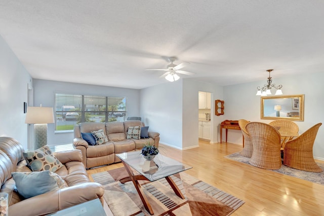 410 High Point Dr Unit C, Delray Beach, FL 33445 - living room with light wood-style floors, a chandelier, a ceiling fan, and baseboards