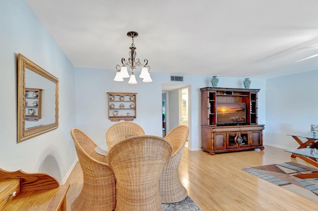 410 High Point Dr Unit C, Delray Beach, FL 33445 - dining space with a chandelier, light wood-style flooring, and baseboards