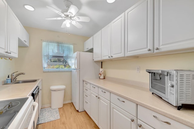 410 High Point Dr Unit C, Delray Beach, FL 33445 - kitchen with stove, a sink, white cabinetry, and light wood finished floors