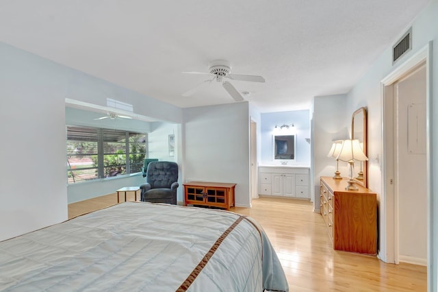 410 High Point Dr Unit C, Delray Beach, FL 33445 - bedroom with light wood finished floors, ensuite bath, and a ceiling fan