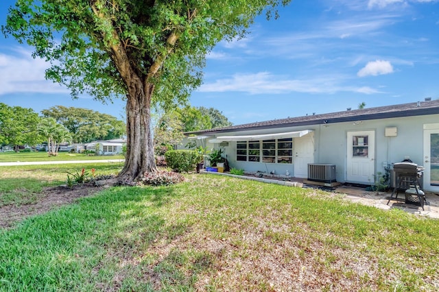 410 High Point Dr Unit C, Delray Beach, FL 33445 - rear view of property with central AC unit, a lawn, stucco siding, and a patio